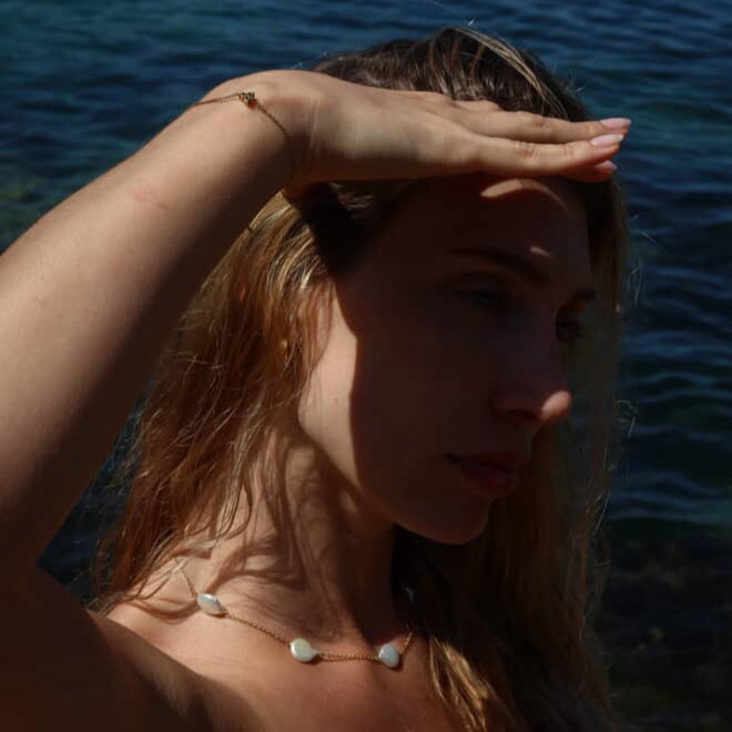 Woman in Paula Freshwater Pearl Necklace at the beach